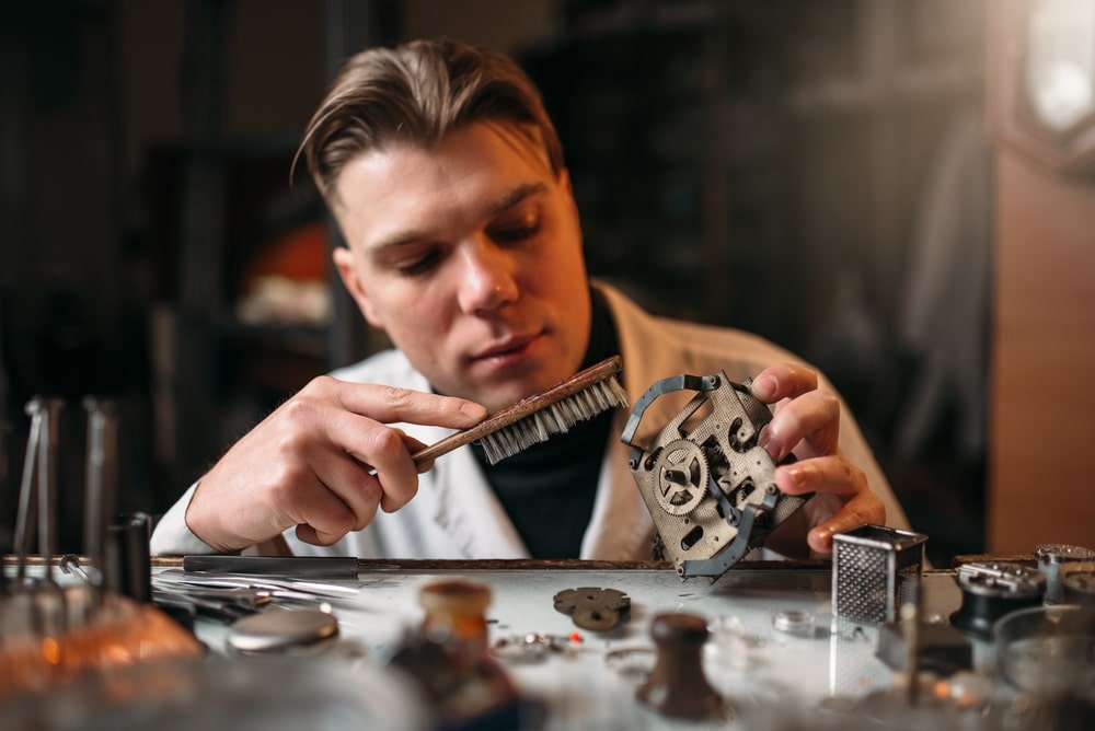 A man is A man is cleaning an old mechanisman old mechanism