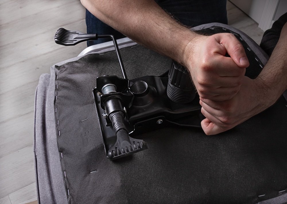 Man dismantling the seat pad