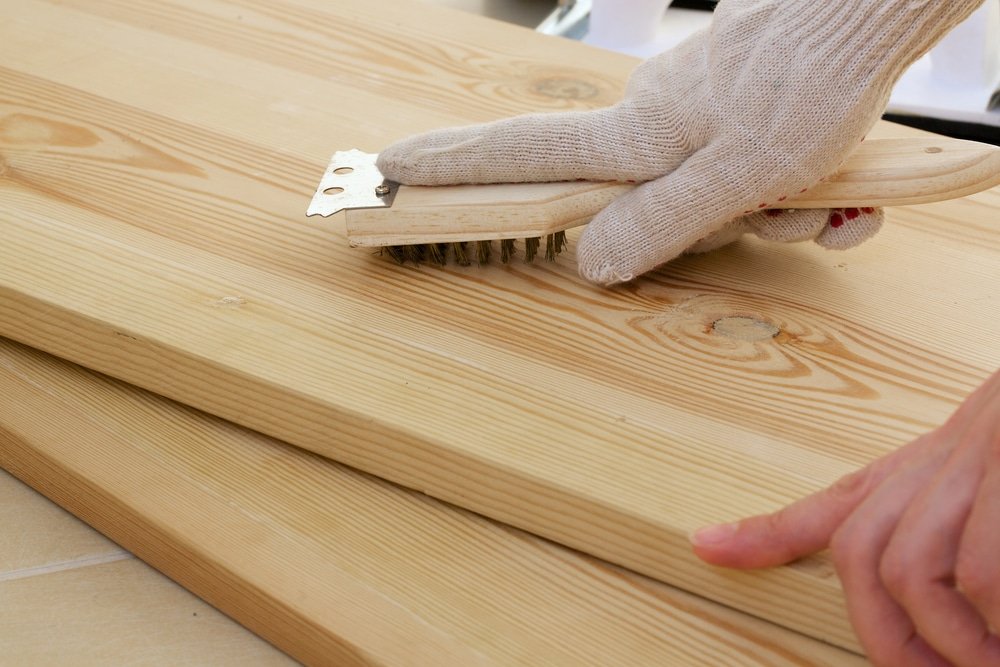 Polishing the wooden piece using a brush