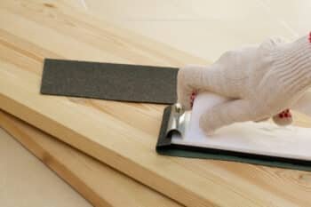 Sanding wooden piece before painting