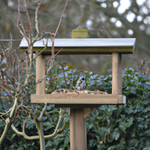 a bird table near hedge