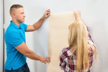a couple trying to decor their wall