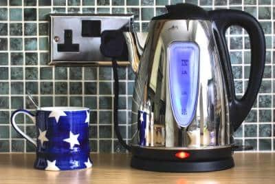 a cup and an electric tea pot