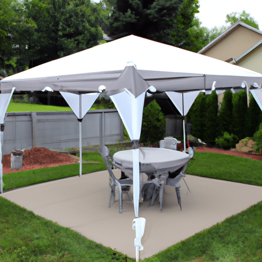 a gazebo with grey canopy and a round table