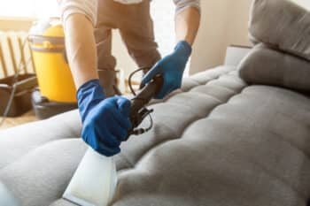 a person tidying the sofa