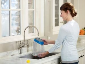 a woman cleaning the tank of a deep cleaning machine