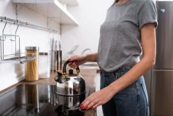 a woman preparing to boil hot water