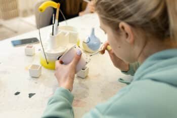a young girl making ornaments on her mug