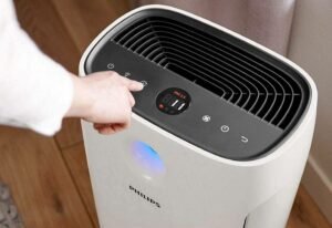 closeup of hand operating air filtration device