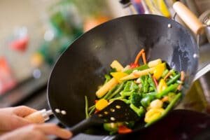 cooking veggies in a wok