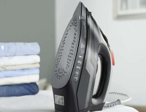 flatiron and folded clothes on table