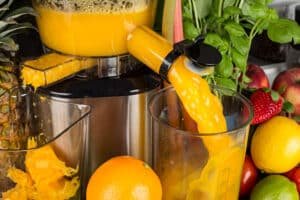 fresh juice being poured in a glass