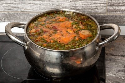 full saucepan on glass stovetop
