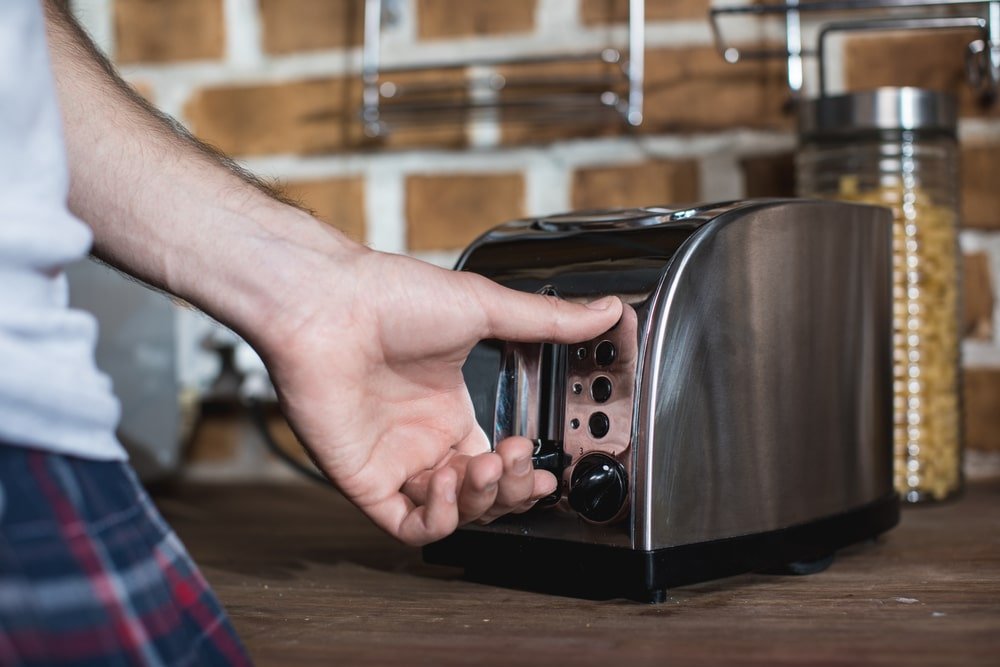 man checking on the toaster