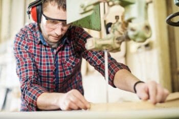 man cutting wood