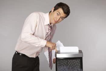man shredding documents