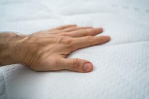 man testing bed
