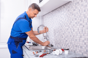 plumber working on the kitchen sink