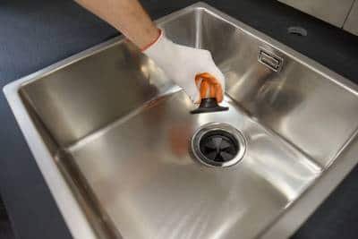 removing a sewer lid of a garbage disposer