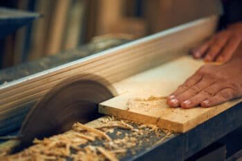 worker cutting wood in shop