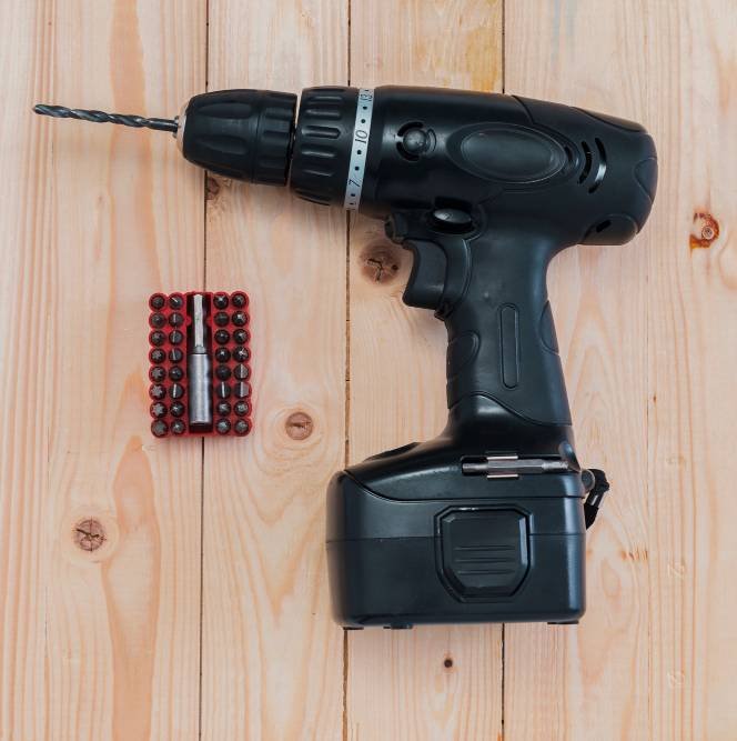 a brushless cordless drill on a wooden table