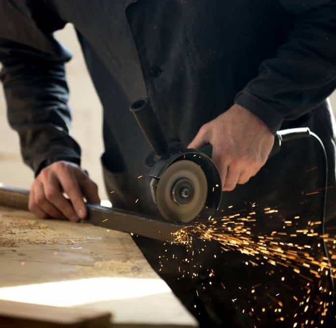a craftsman working with an electric tool in the workshop