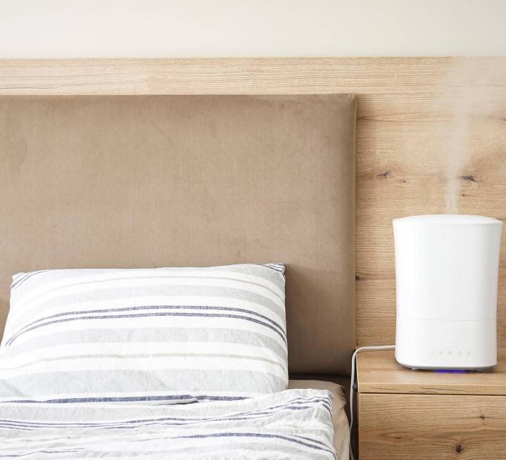 a humidifier in the bedroom by the bed