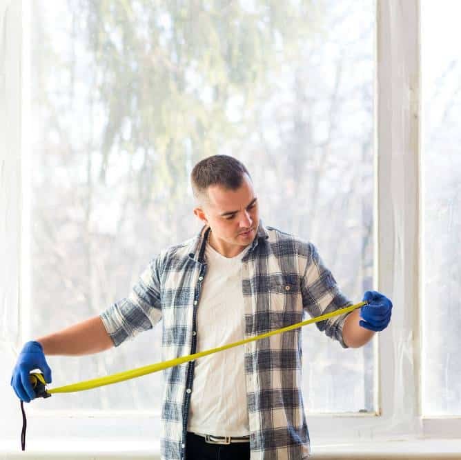 a man looking at tape measure