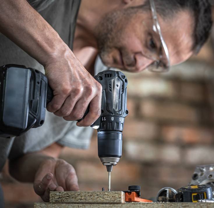 a man screwing a self-tapping screw