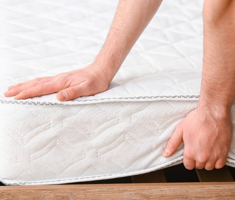 a man testing an orthopedic mattress