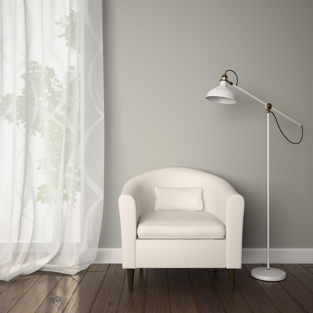 a room with white armchair and floor lamp