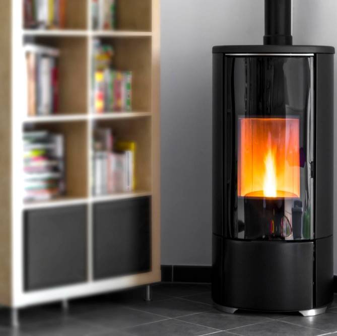 a small electric fireplace by the bookcase