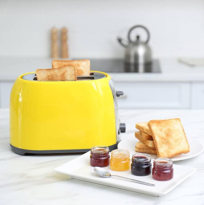 a toaster with slices of bread and different jams