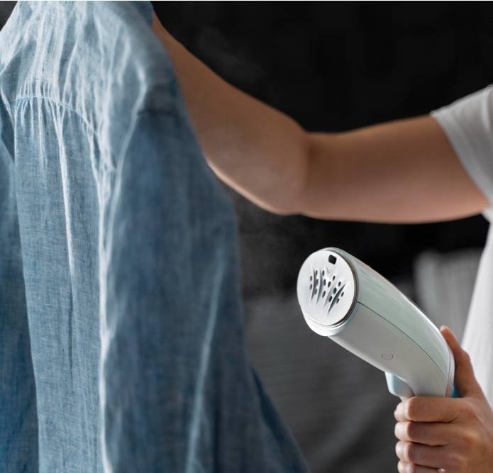a woman ironing her shirt