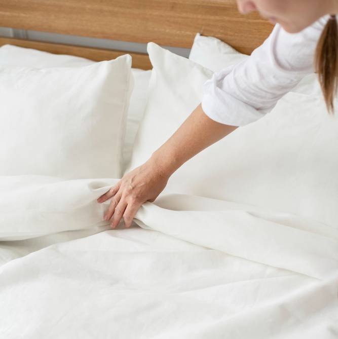 a woman making the bed