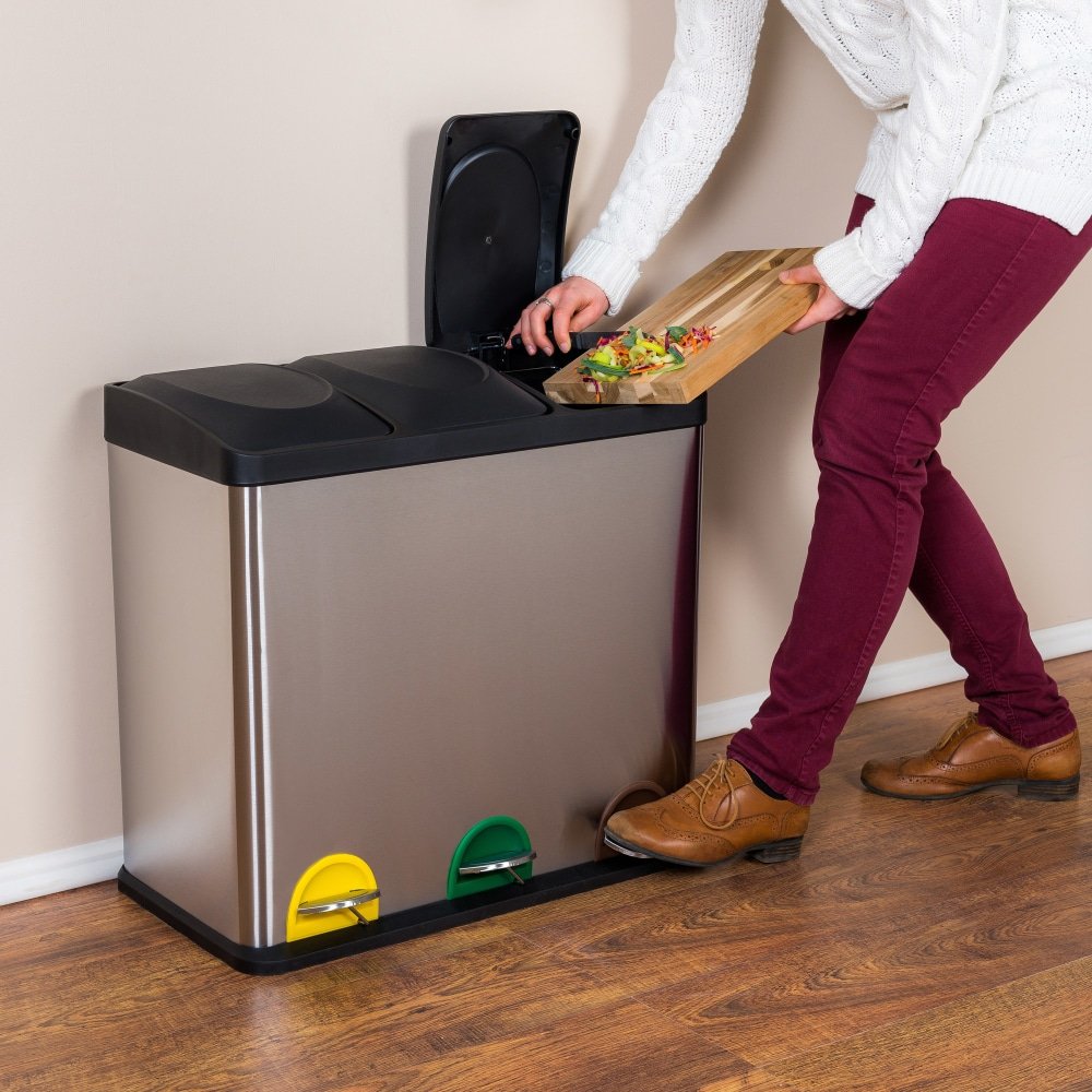 a woman throwing the wasted food into the steel bin