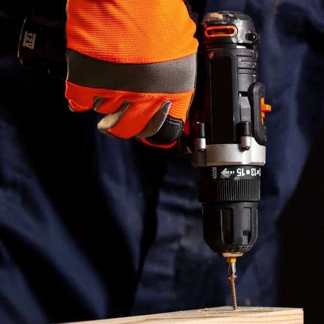 a worker using a cordless drill