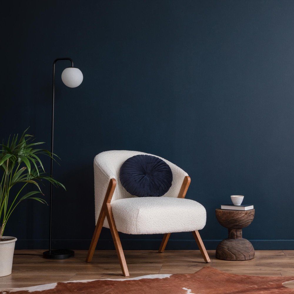 an elegant living room with a fluffy armchair and floor lamp