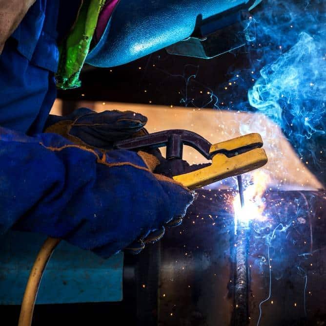 an industrial worker at the factory welding