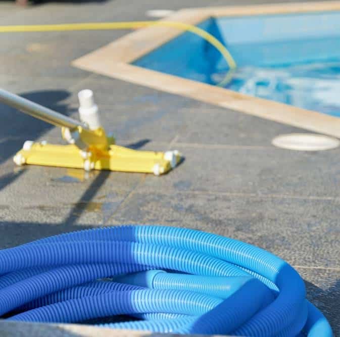 cleaning the pool using water vacuum cleaner