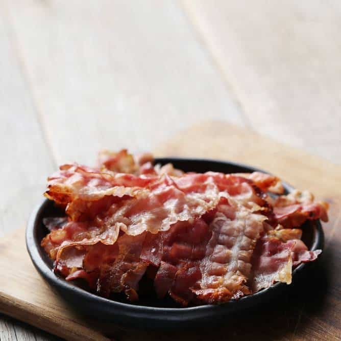 fried bacon on black plate