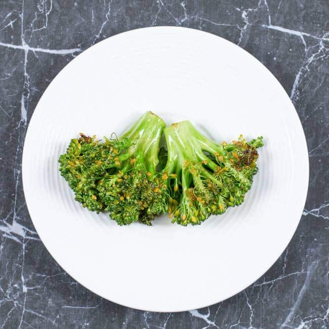 fried fresh broccoli on a white plate