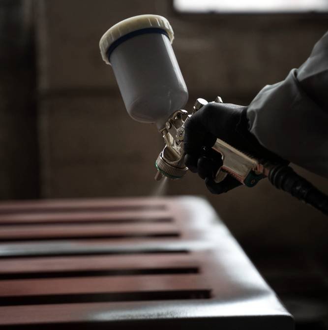 painting a metal chair using an air sprayer